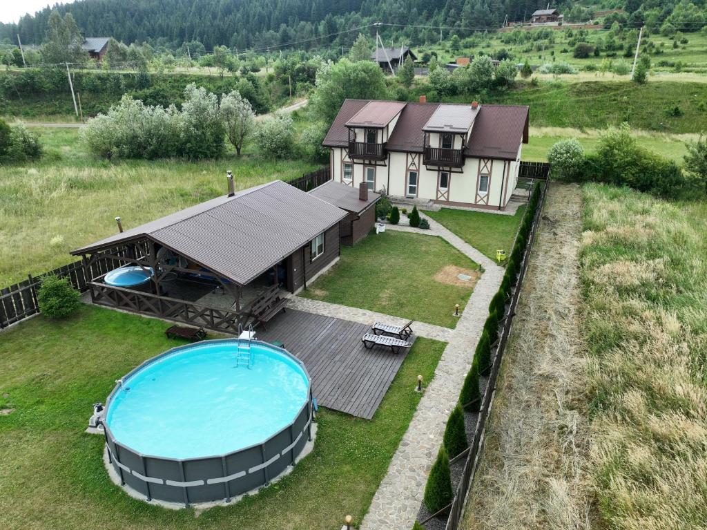 an aerial view of a house with a swimming pool at Котедж "Під Горбком" in Korchin