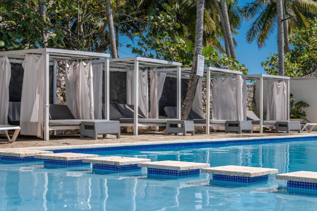 a swimming pool with chaise lounges and a resort at Tribe Boutique Resort by Mega Stays in Guayacanes