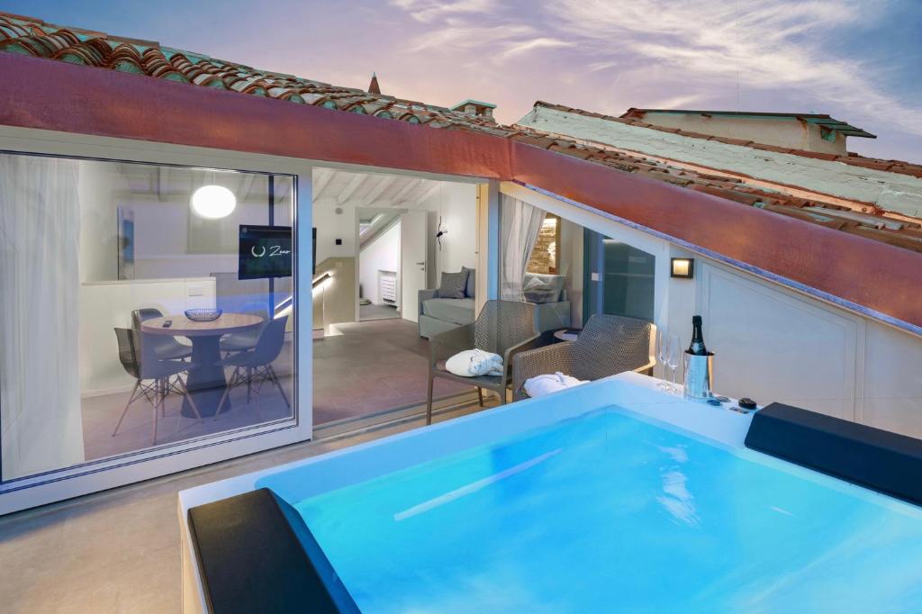 a house with a swimming pool and a living room at Zeno Suites in Verona