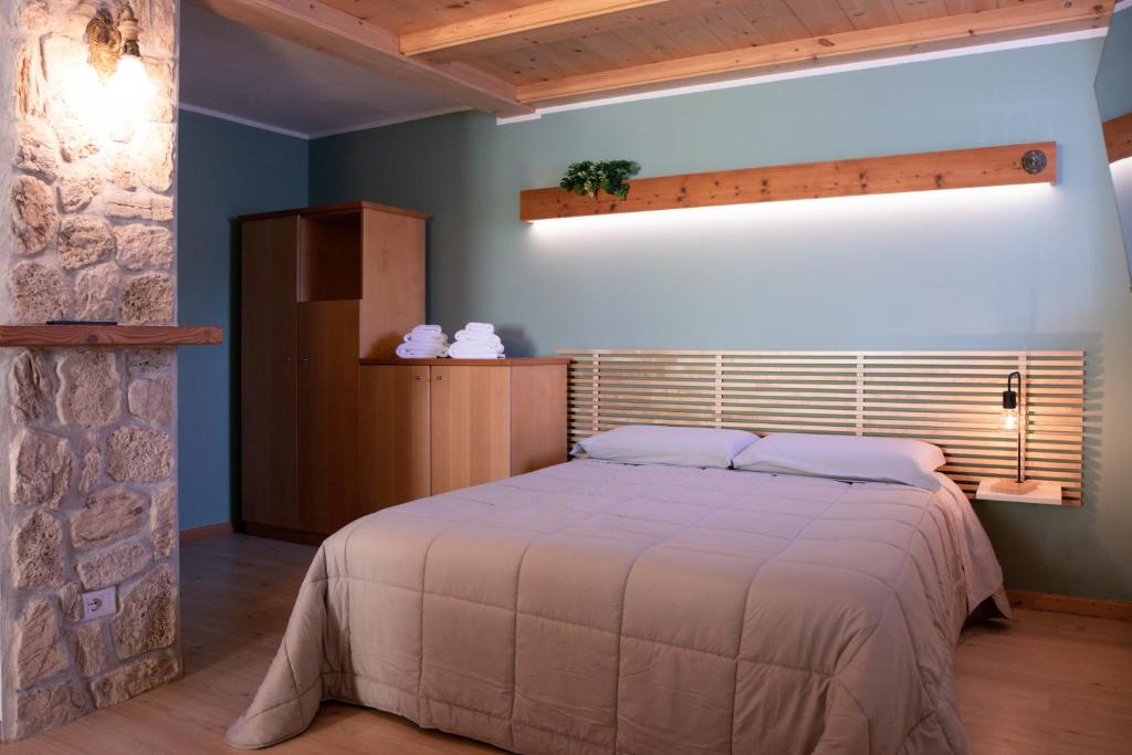 a bedroom with a bed in a room at Dolomiti Nest in Tesero