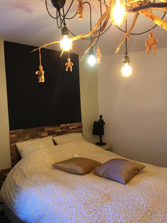 a bedroom with a bed with lights on it at Maison Parnasse in Castelnau-de-Guers