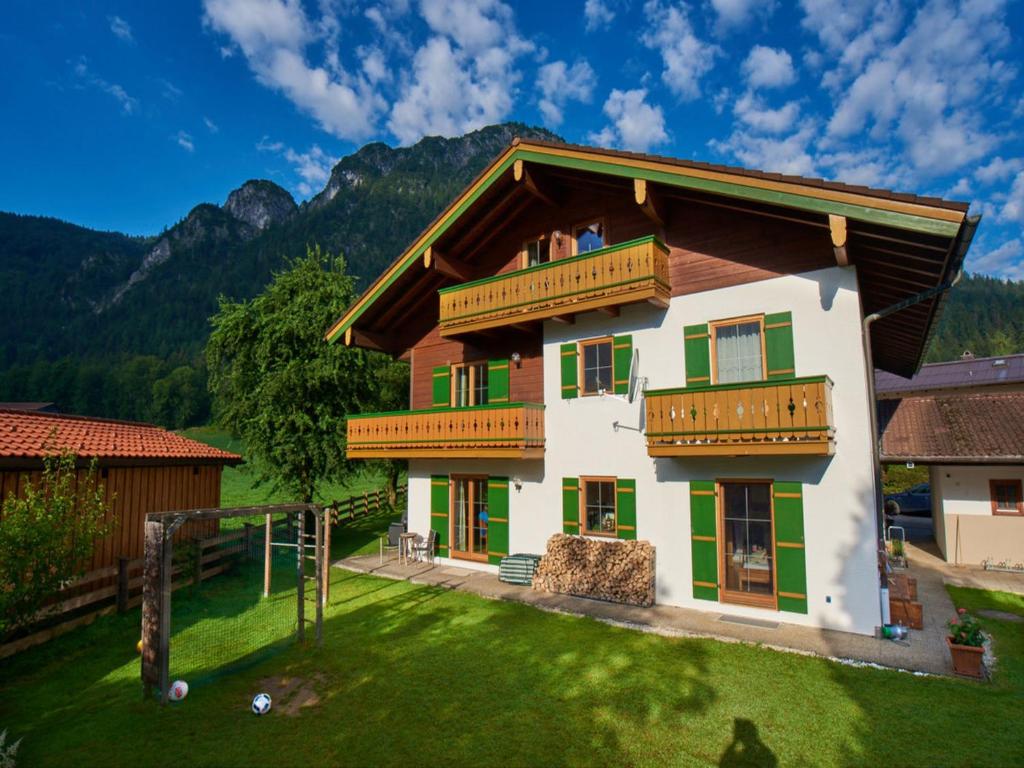 a house in the mountains with a yard at Haus Thiele in Schönau am Königssee