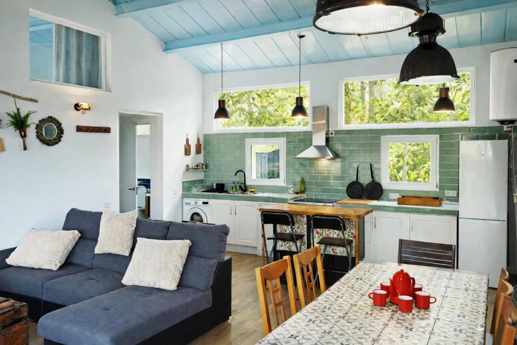 a living room and kitchen with a blue couch at El Pinsapo in Segovia