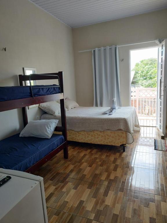 a bedroom with two bunk beds and a window at Pousada Riocabana in Barreirinhas