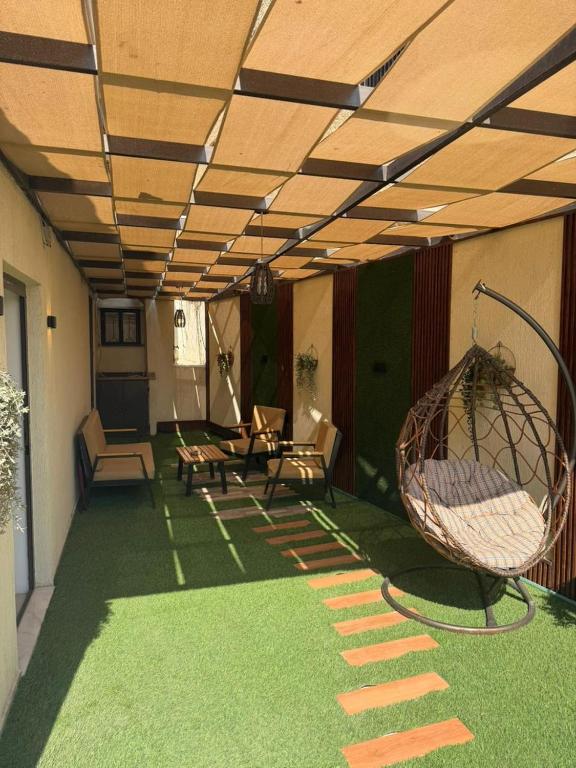 a living room with green grass and a swing at Salam Apartments in Amman