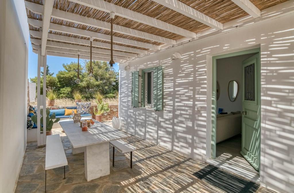 a patio of a house with a wooden ceiling at Villa Paros Spiti Mataki in Aliki