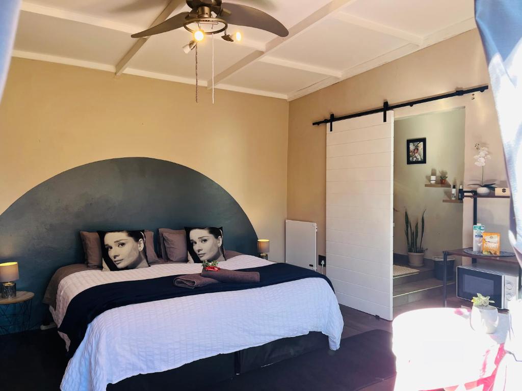 a bedroom with a large bed with two men on it at Casa De Montague in Noordheuwel