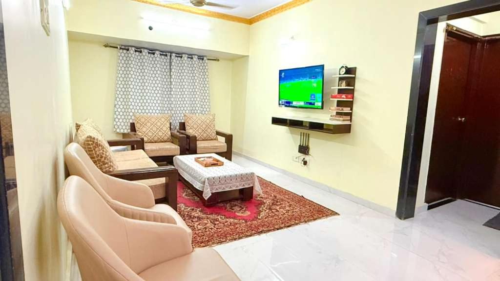 a living room with a couch and a tv at Spacious 2BHK flat in new panvel in Navi Mumbai