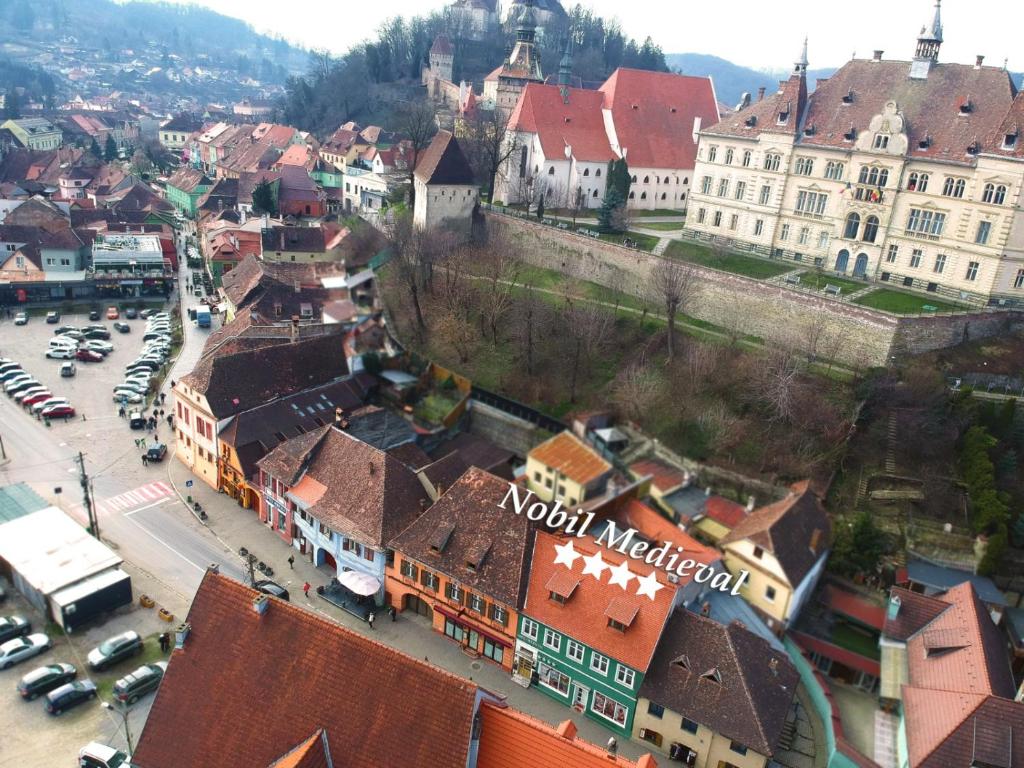 an aerial view of a city with buildings and cars at Pensiunea Nobil Medieval in Sighişoara