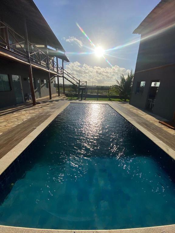 a pool of water in front of a building at Suítes Taipu de Fora in Marau