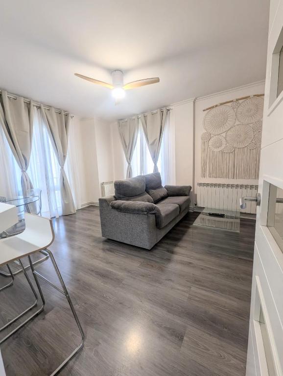a living room with a couch and a ceiling fan at Apartamentos Crispin Anais in Corella