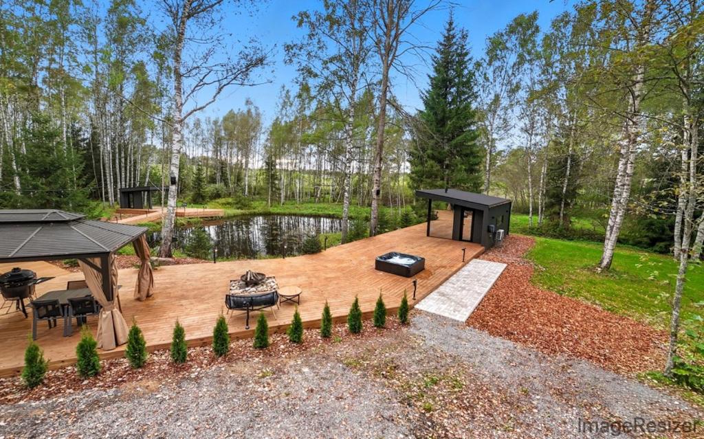 a backyard with a gazebo and a grill at Luxury Resort Päikeseoru in Pedajamäe