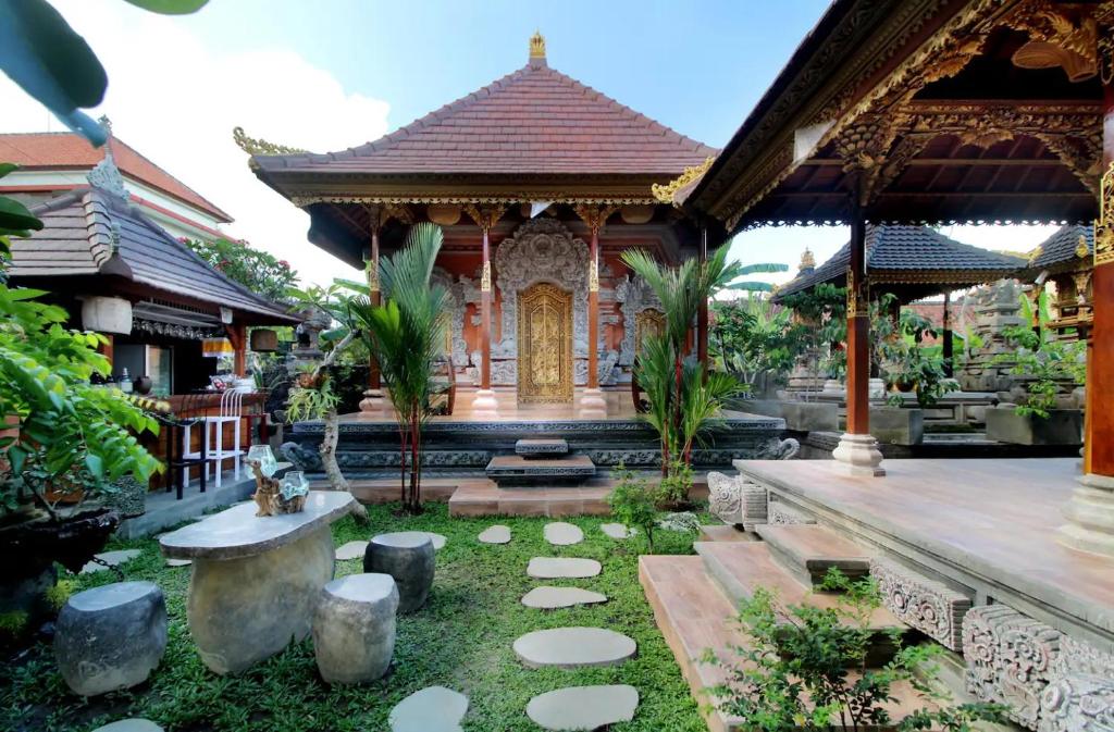 a garden in front of a building with a gold door at Tri Datu Palace in Saba