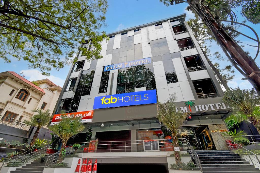 a building with a sign on the front of it at FabHotel Palm Tree in Hyderabad