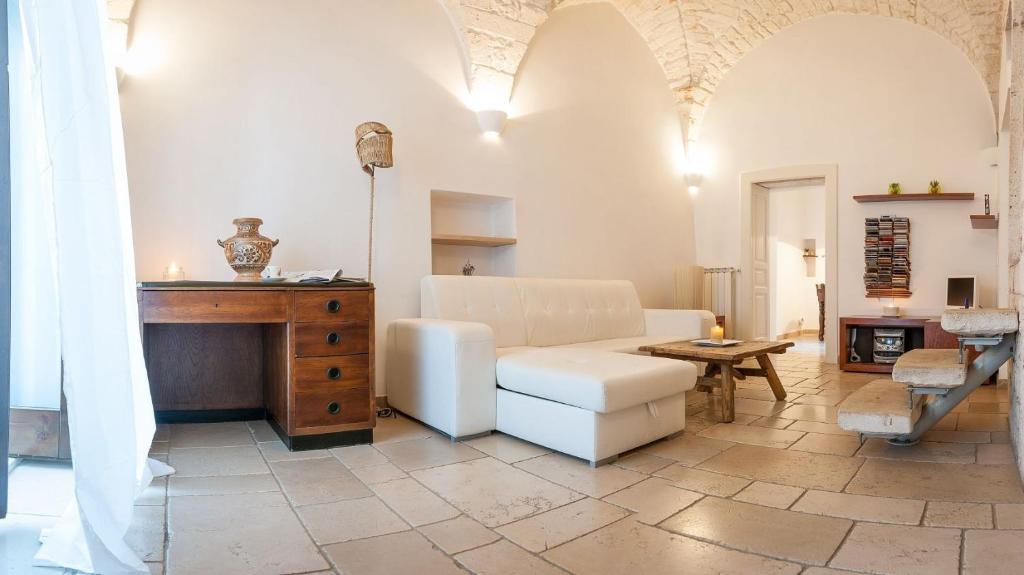 a living room with a white couch and a table at Appartamento Panorama in Ostuni
