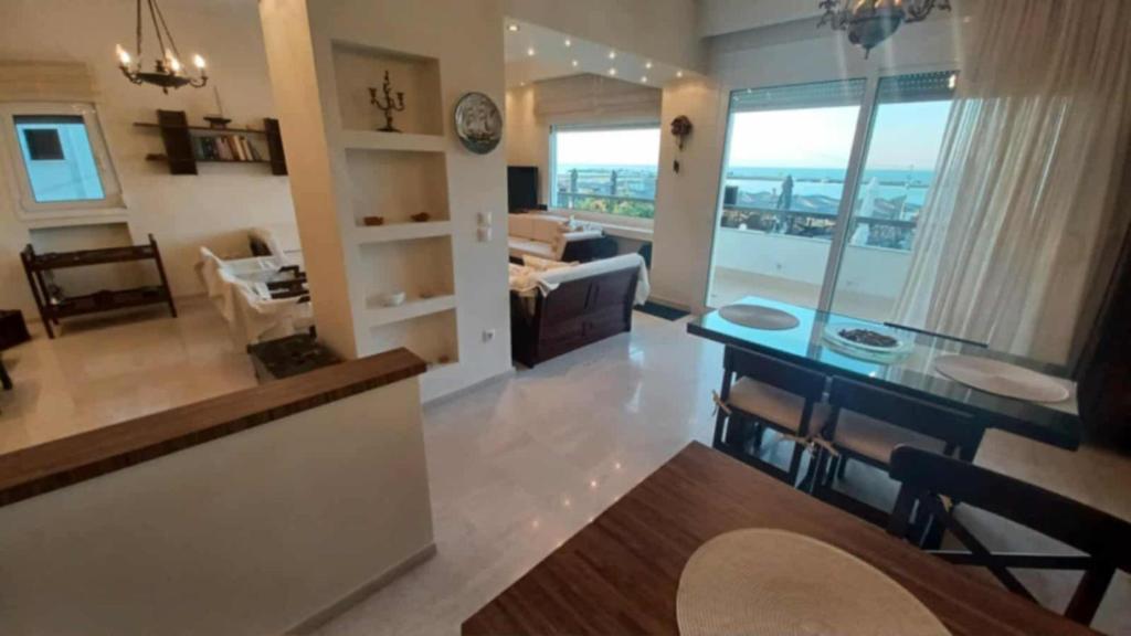 a kitchen and living room with a table and a view at Villa Veranda in Neoi Epivates