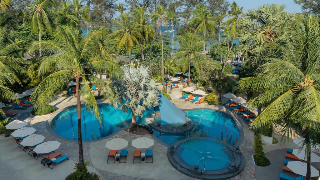 an overhead view of a resort pool with palm trees at Holiday Inn Resort Phuket, an IHG Hotel in Patong Beach