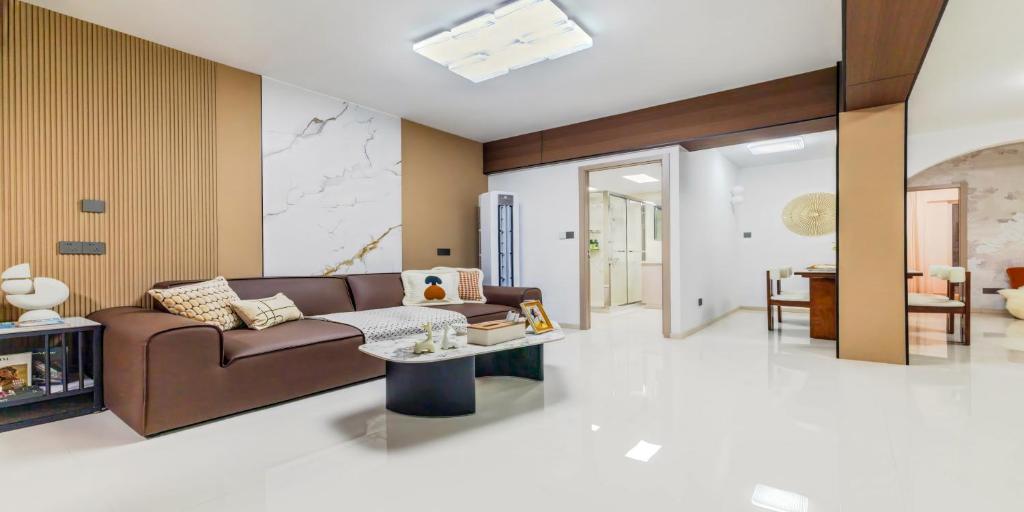 a living room with a brown couch and a table at 上海NICE民宿 Shanghai NICE B&B ZFC in Shanghai