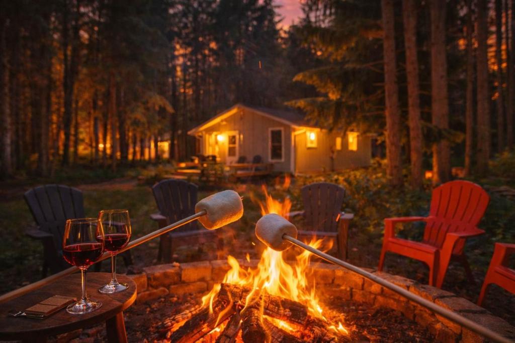 a fire pit with two wine glasses and a bonfire at Shanty Creek, Golf, Families, Vacation, Pool Pass in Bellaire