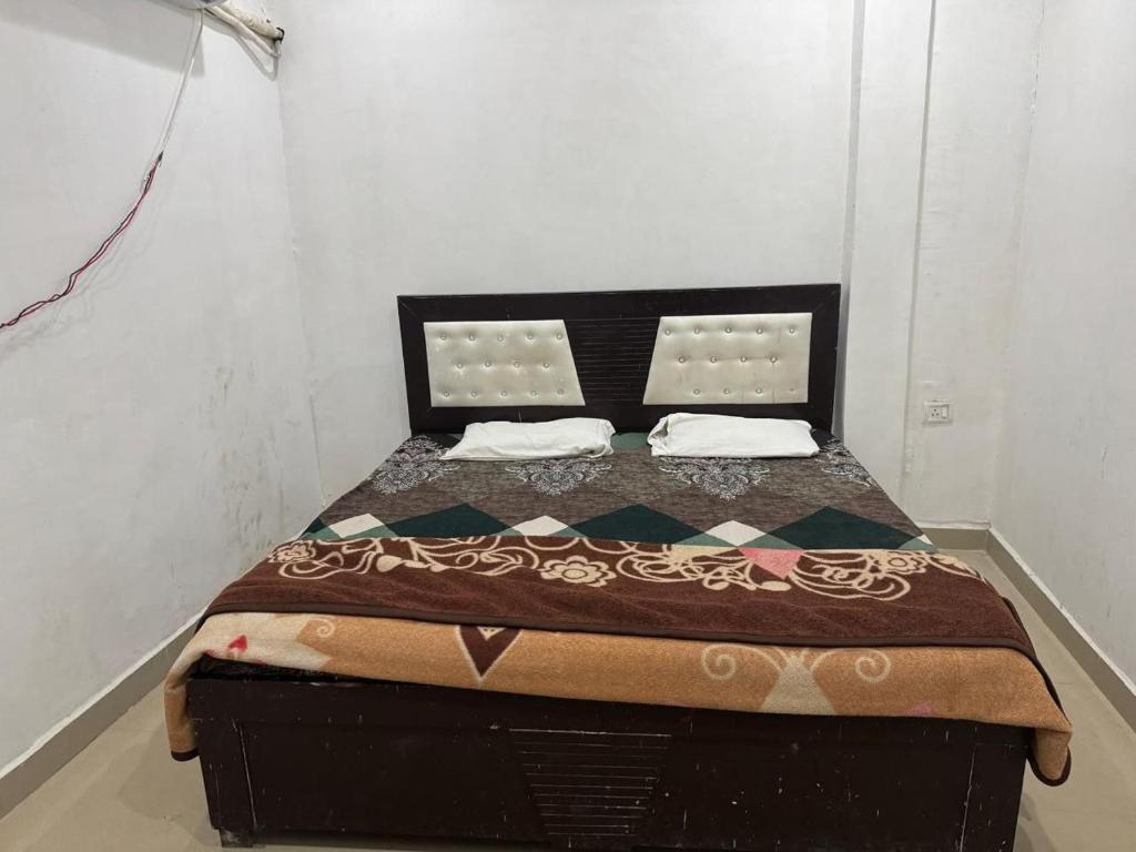 a small bedroom with a bed in a room at HOTEL INDRANEEL Hanuman Garhi in Ayodhya