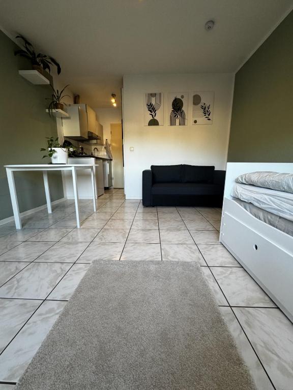a living room with a couch and a table at 1-Zimmer Apartment Waldperle in Erftstadt