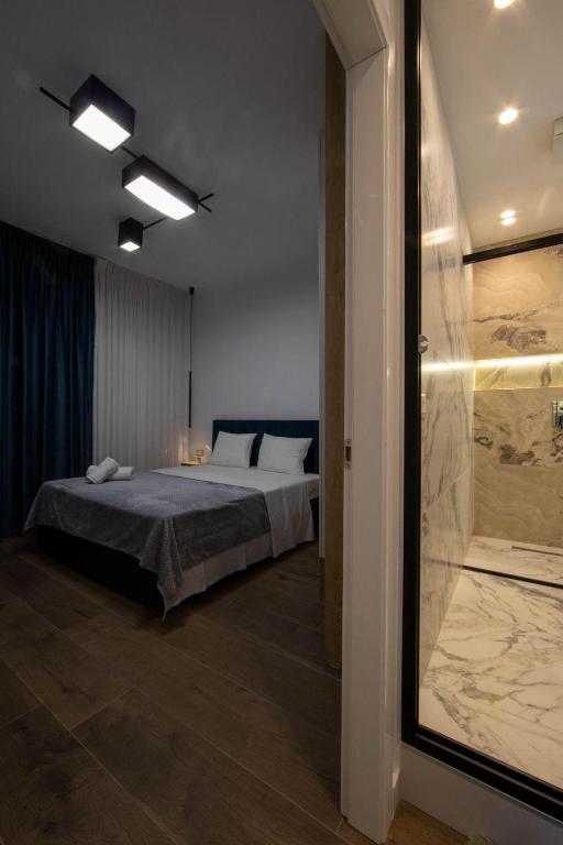 a bedroom with a bed and a sliding glass door at Bliss Modern Retreat in Tirana