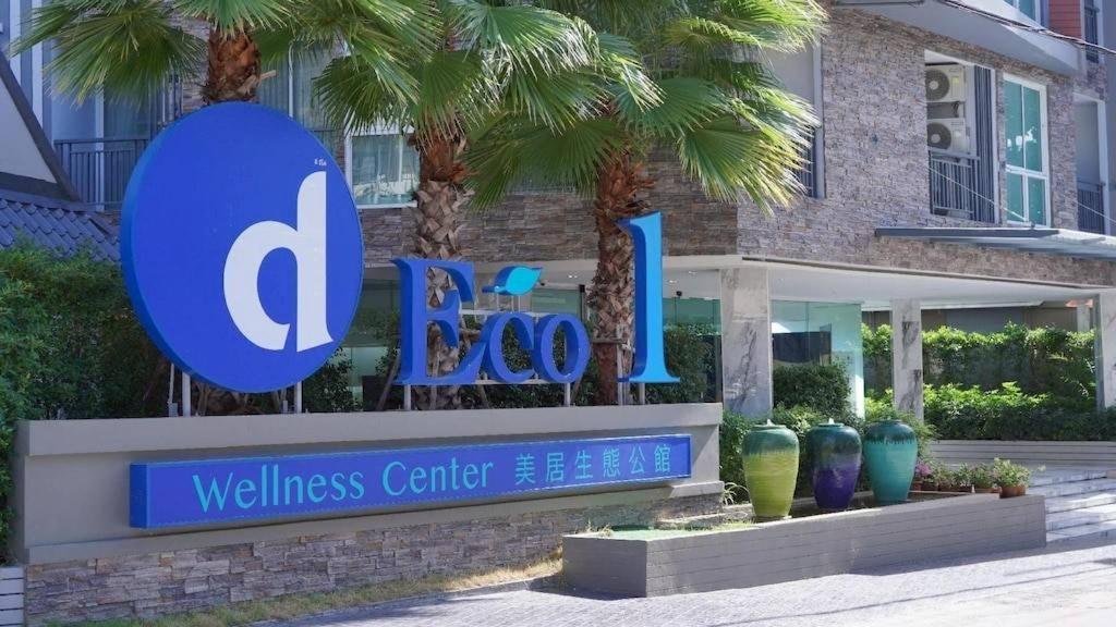 a sign for a wellness center in front of a building at Condo D-Eco Wellness Center A8721 in North Pattaya