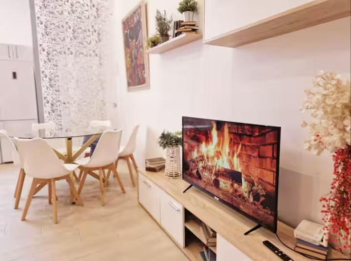 a living room with a flat screen tv on a table at Rota Beach Loft in Rota
