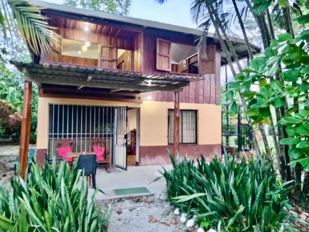 a house with a patio in front of it at Casa Almendros in Cabuya