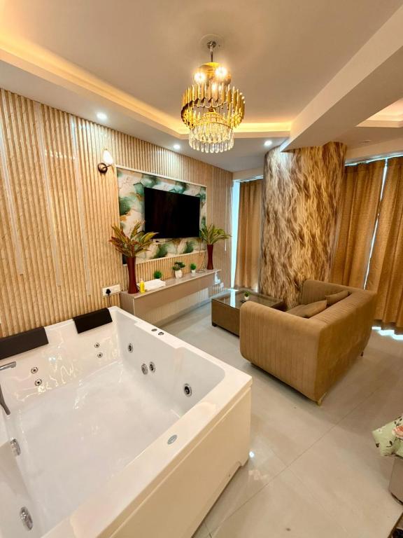 a large living room with a tub and a couch at Luxury Jacuzzi Studio -Couple Friendly- Noida in Ghaziabad