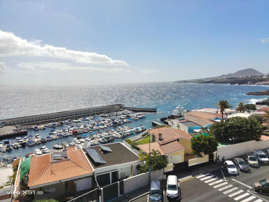a view of a harbor with a lot of cars at The beach nest in Candelaria