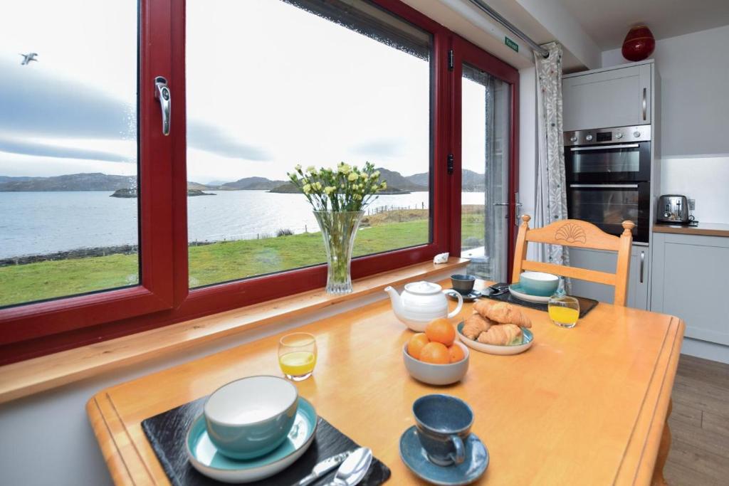 a kitchen with a table with food on it at 1 Bed in Reef oc-r30134 in Uig