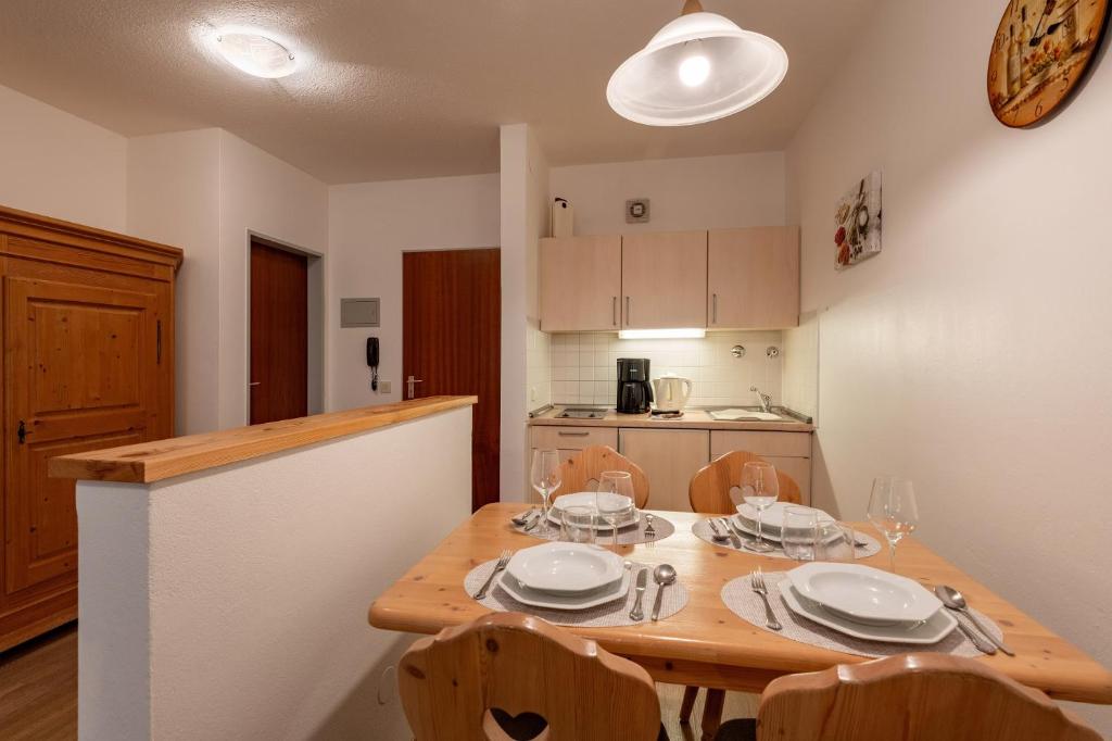 a kitchen with a wooden table with plates on it at Bergschlössl Whg 3 in Oberaudorf