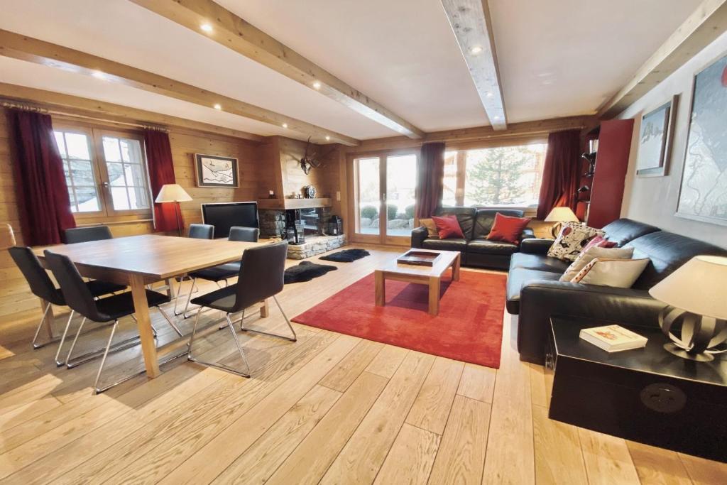 a living room with a table and a couch at Eclat de Soleil 023 in Verbier