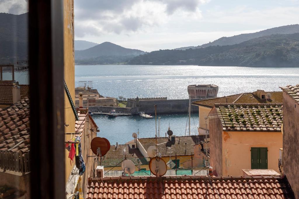 a view of a body of water from a building at Tra Tetti e Mare - HelloElba in Portoferraio
