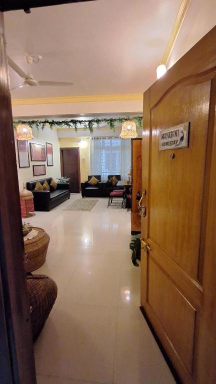 a room with a door and a living room at Mayabini Homestay 3BHK in Guwahati