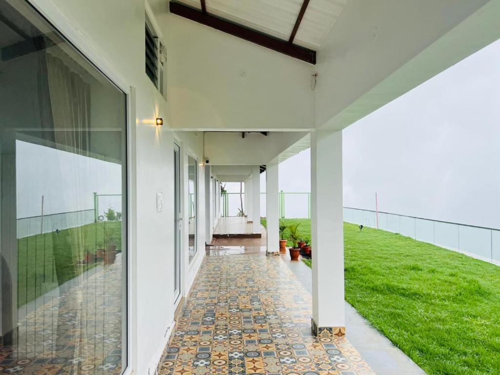 an external view of a house with a walkway at Bison Trails Valley View Kothagiri Ooty Tamilnadu in Kotagiri