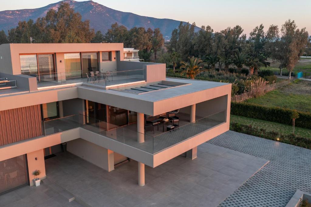 a rendering of a house with mountains in the background at Sun and Sea Apartment - Beachfront, 2 Bedrooms with Sea View & Garden in Paralio Astros