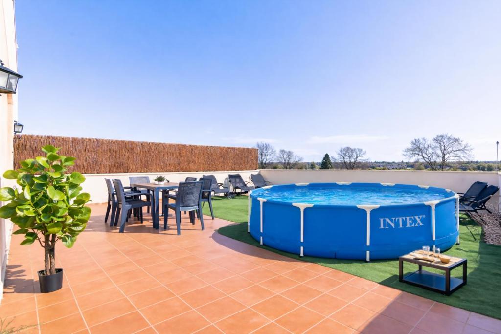 a hot tub on a patio with a table and chairs at Jouvacations Ripolles Figueres-Vilafant in Vilafant