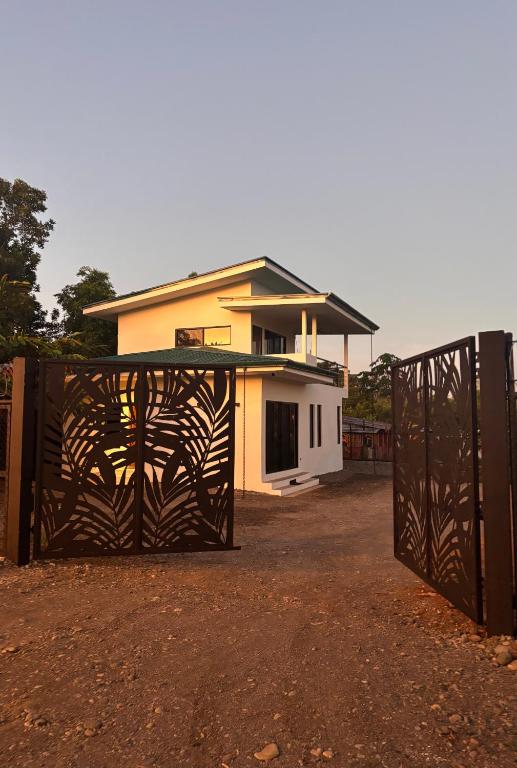 a house with a gate in front of it at Villa Nomad in Naranjito