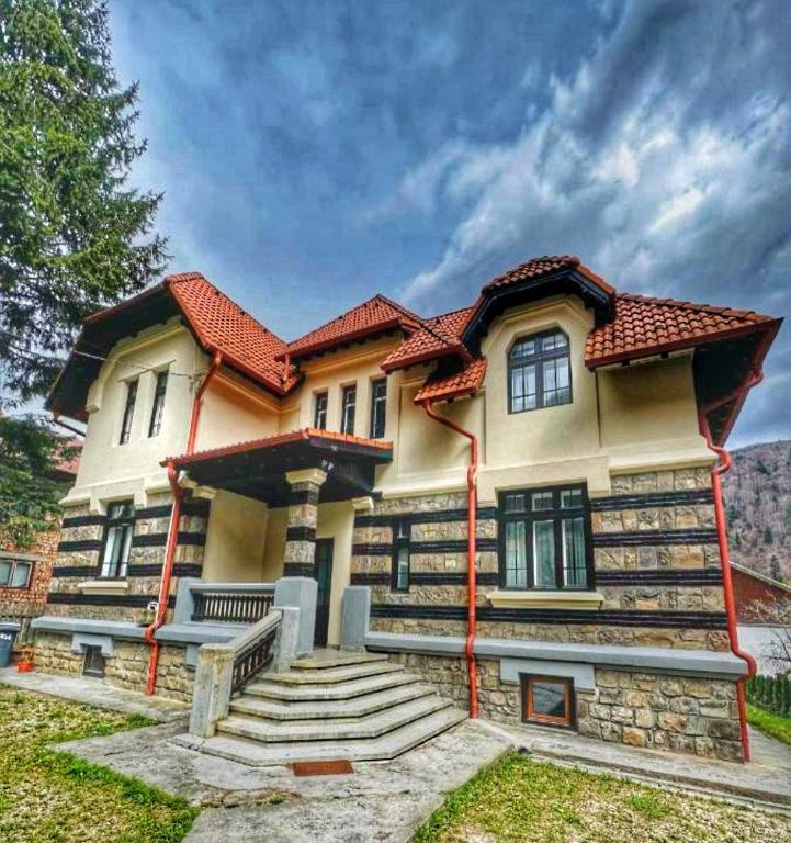 a large house with a red roof at Vila Rapsodia Sinaia in Sinaia