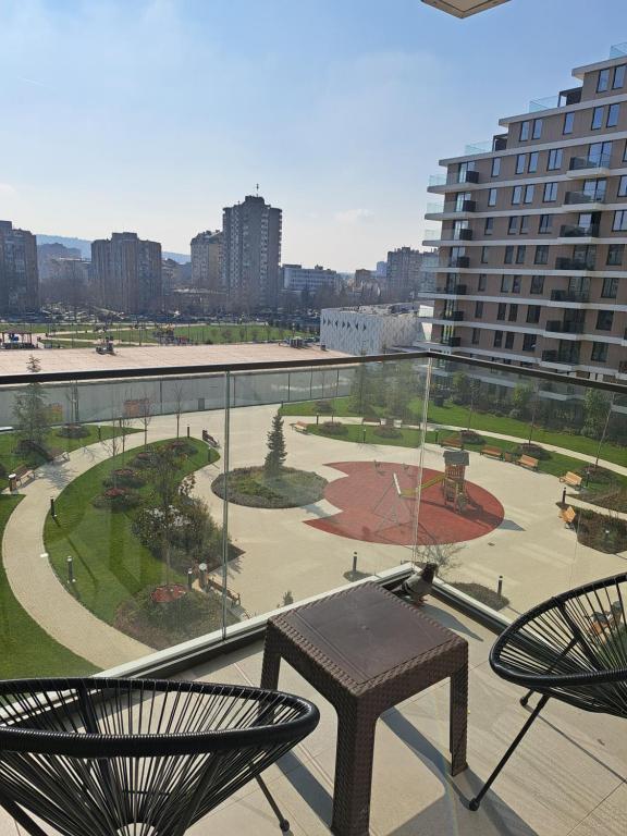 a balcony with a view of a park and buildings at Tea Planet 2 in Niš