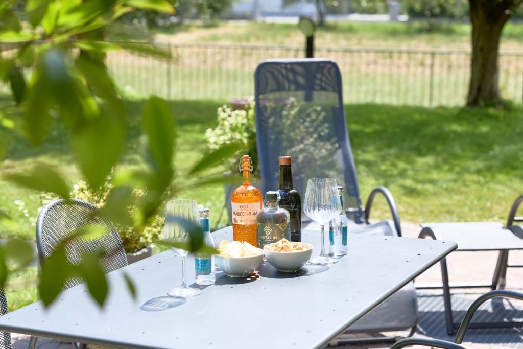 a white picnic table with bottles and glasses on it at Casa Carla in Nago-Torbole