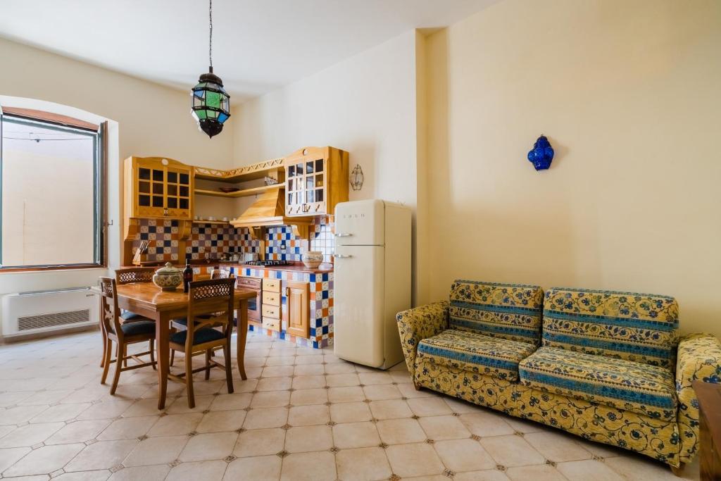 a living room with a couch and a table at Dimora Cariddi Otranto in Otranto