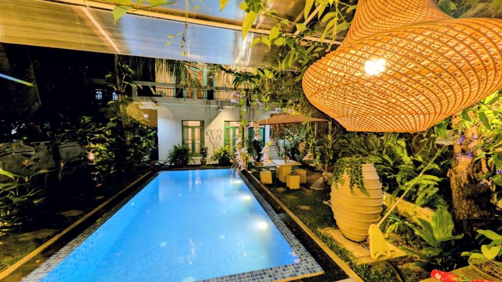 a large indoor pool with plants in a building at Soul Villas in Tangalle