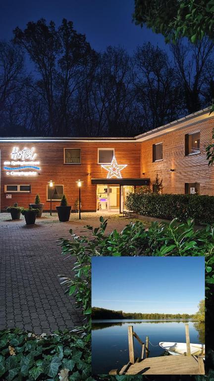 a building with a sign on the side of it at Hotel am Springhorstsee in Großburgwedel