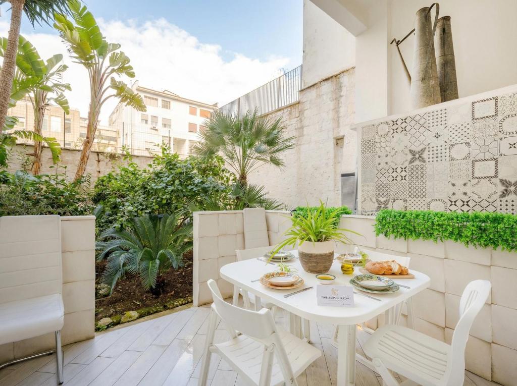 a white table and chairs on the balcony of a building at Lemon Tree House in Bari