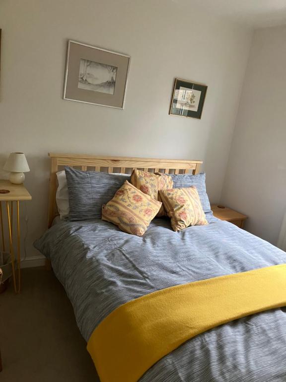 a bed with two pillows on it in a bedroom at The Pudd in Aylesbury