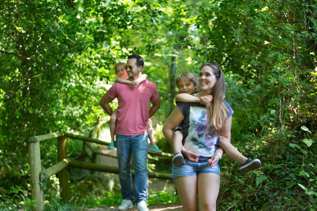 a group of people standing in the woods at Castle Brake Holiday Park in Woodbury
