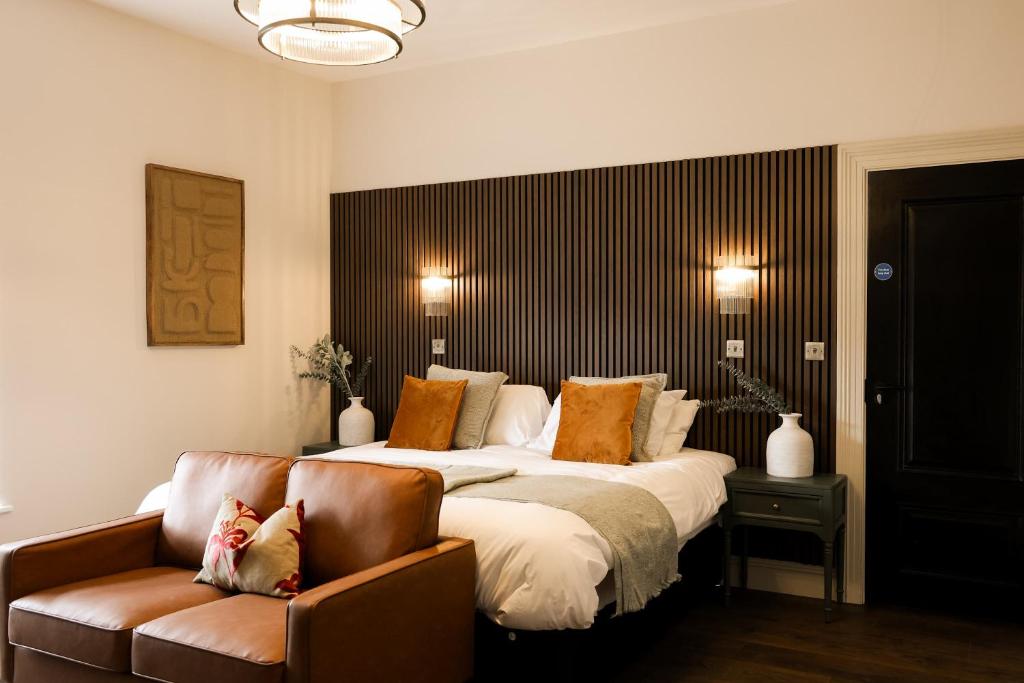 a bedroom with a large bed and a couch at Lovely Studio Flat on Bath Road - Flat 8 in Bristol
